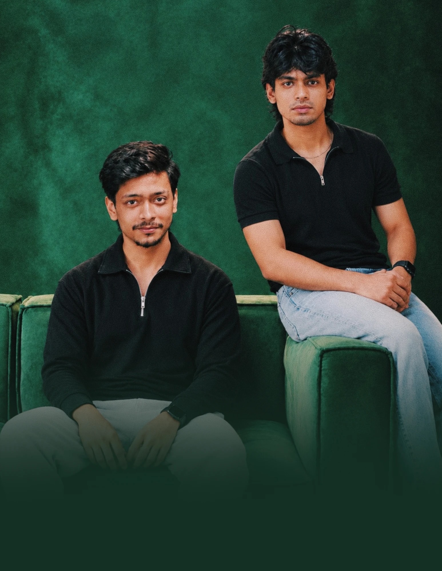 Payriz founders Fahmid and Rakib sitting on a green sofa